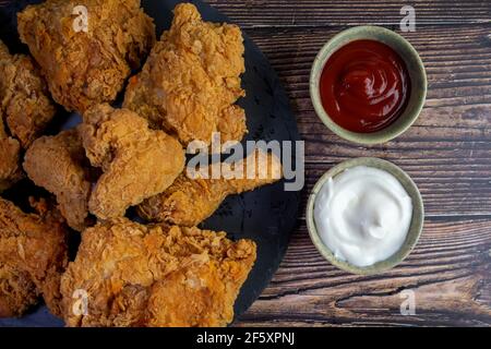 fried chicken flat photography with ketchup and garlic dip on a wooden table. Stock Photo