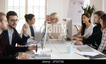 Diverse multiracial businesspeople work on computers in office Stock Photo