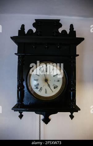 Antique old vintage clock on white wall. Stock Photo