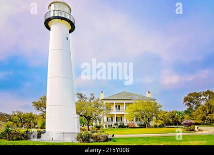 The Biloxi Lighthouse is pictured with the Biloxi Welcome Center, March 27, 2021, in Biloxi, Mississippi. The lighthouse was erected in 1848. Stock Photo