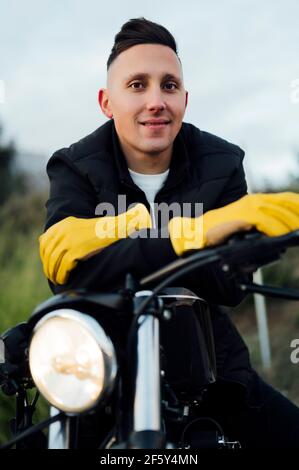 Portrait of man on motorcycle with yellow gloves Stock Photo