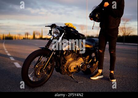 Unrecognizable man near the motorcycle standing holding the helm Stock Photo