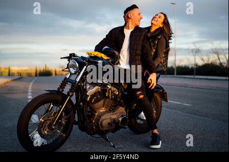 Portrait of happy couple on motorbike Stock Photo