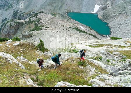 High angle view of male and female friends hiking on mountain during vacation Stock Photo