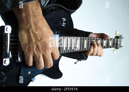 Man playing Gibson Les Paul Studio T ebony guitar close up fingers Stock Photo