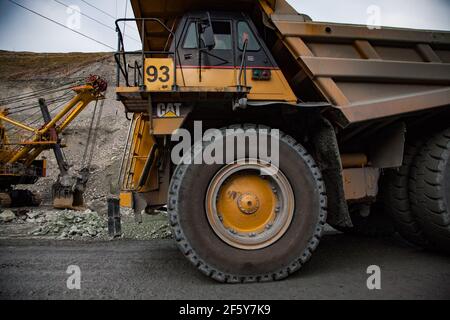 Rudny/Kazakhstan - May 14 2012:  Open-pit mining iron ore in quarry. Excavator and Caterpillar quarry truck. Stock Photo