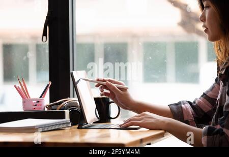 Asian Graphic Designer working with interactive pen display, digital Drawing tablet and Pen Stock Photo