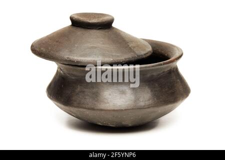 Clay pot with lid made of special black clay for cooking, isolated on a white background Stock Photo