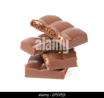 Broken porous chocolate bars in a stack isolated on white background Stock Photo