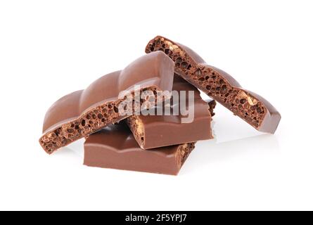 Heap of porous chocolate bars on white background with shadow and reflection Stock Photo