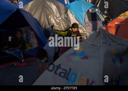 Tijuana, Mexico. 27th Mar, 2021. Migrants are seen at thMigrants from Central America are stuck living in tents on the street in Tijuana, Mexico on the border while they wait for President Joe Biden to open the American border. Credit: Allison Dinner/ZUMA Wire/Alamy Live News Stock Photo