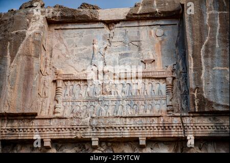 Relief decorations above the entrance to the tomb of the Persian king Artaxerxes II at Persepolis in Iran Stock Photo