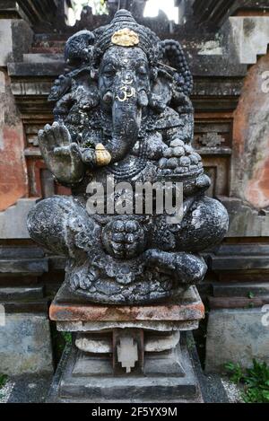 A rock carved statue of the Hindu got Ganesh in a temple in Ubud, Indonesia. Stock Photo