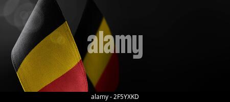 Small national flags of the Belgium on a dark background Stock Photo