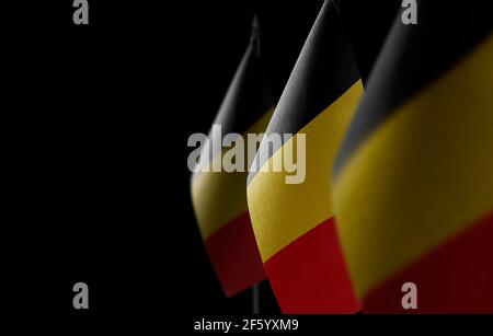 Small national flags of the Belgium on a black background Stock Photo