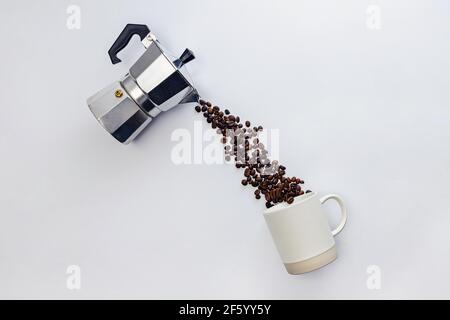 Coffee beans pouring from moka pot. Stock Photo