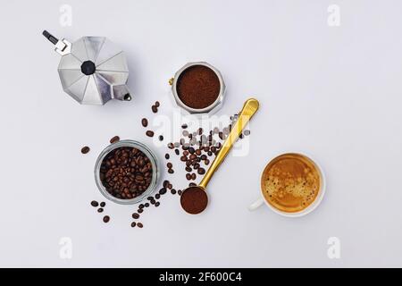 Still life with moka pot, coffee beans and fresh hot espresso in a cup Stock Photo