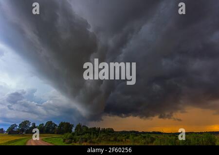 Supercell storm clouds with wall cloud and intense rain Stock Photo