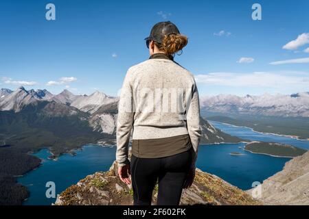 Female traveler enjoying the view from Sarrail Ridge during summer in Kananaskis Country, Alberta, Canada. Stock Photo