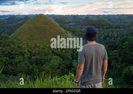 Traveler looking at view at natural landmark Chocolate Hills in Bohol island, Philippines. Stock Photo