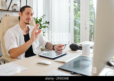 Graphic designer having online meeting with client when they are discussing details of new project Stock Photo