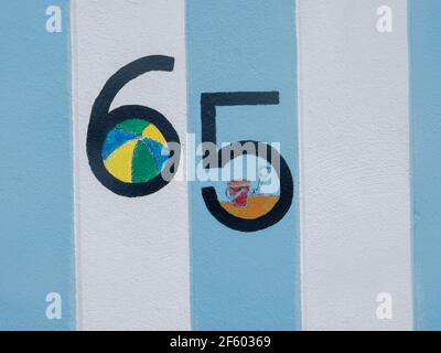 Number 65 written on a wooden frame. Stock Photo