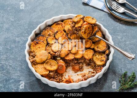 Cottage pie with sweet potato medallions topping Stock Photo