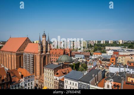 Torun, Poland - August 2020 : The Church of the NMP  Najswietszej Maryi Panny  surrounded by buildings under the sunlight and a blue sky in Torun Old Stock Photo