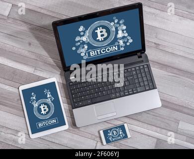 Bitcoin concept shown on different information technology devices Stock Photo