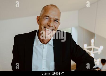 Portrait of smiling businessman in office Stock Photo