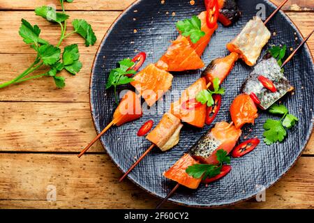 Pieces of dried salted salmon on skewers.Salty red fish.Organic fish Stock Photo