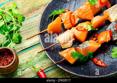Kebabs from dried and salmon on wooden skewers.Delicious smoked fish Stock Photo