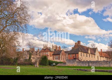 Ancient buildings of the City of York set under a sky with heavy cloud.  The towers of York Minster can be seen in the background. Stock Photo