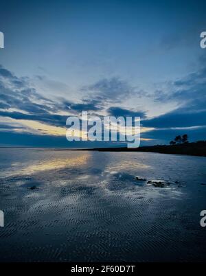 Sunset set over the Solway Firth seen from Powfoot in Dumfries & Galloway, Scotland. Stock Photo