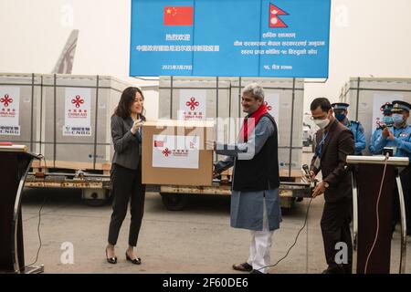 Nepalese Health Minister, Hridayesh Tripathi  (R) Chinese Ambassador of Nepal Hou Yanqi (L) attend a Vero Cell Covid-19 coronavirus vaccine manufactured under license by Sinovac Biotech Institute of china  handover ceremony at Tribhuvan International airport. Nepal has received 800,000 doses of Vero Cell Covid-19 vaccines being manufactured under license by Sinovac Biotech Institute of china donated by the Chinese government. Stock Photo