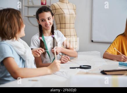 Cute female children working in sewing workshop Stock Photo