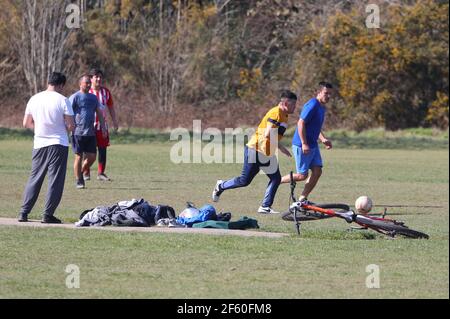 Southampton, Hampshire. 29th March 2021. UK Weather. Friends get together for a game of football on a bright sunny day at Southampton Common as COVID restrictions are relaxed in England. Credit Stuart Martin/Alamy Live News Stock Photo