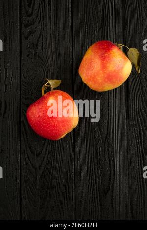 Top view of red apples on the black woooden background Stock Photo