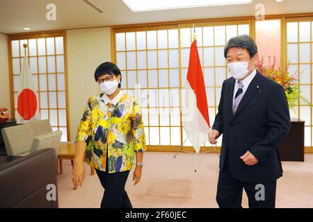 March 29, 2021, Tokyo, Japan: TOKYO, JAPAN - MARCH 29 : Toshimitsu Motegi, Japan's foreign minister (R) and Indonesian Foreign Minister Retno Marsudi (L), wearing protective face masks, head to the meeting room as they attend the Japan-Indonesia Foreign Ministers meeting in Tokyo, Japan, on Monday, March 29, 2021. Indonesian Foreign Minister Retno Marsudi and Defense Minister Prabowo Subianto are in Japan from March 28-30, 2021. Retno and Prabowo will also hold a second 2 and 2 meeting between Foreign Ministers and Defense Ministers of two countries on Tuesday, March 30, 2021. The two countrie Stock Photo