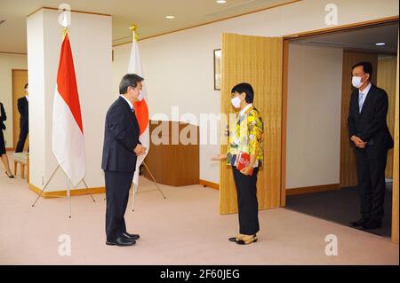 March 29, 2021, Tokyo, Japan: TOKYO, JAPAN - MARCH 29 : Toshimitsu Motegi, Japan's foreign minister (L) welcomes Indonesian Foreign Minister Retno Marsudi (C) at the entrance of the meeting room prior to the Japan-Indonesia Foreign Ministers meeting in Tokyo, Japan, on Monday, March 29, 2021. Indonesian Foreign Minister Retno Marsudi and Defense Minister Prabowo Subianto are in Japan from March 28-30, 2021. Retno and Prabowo will also hold a second 2 and 2 meeting between Foreign Ministers and Defense Ministers of two countries on Tuesday, March 30, 2021. The two countries will enter issues in Stock Photo