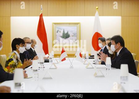 March 29, 2021, Tokyo, Japan: TOKYO, JAPAN - MARCH 29 : Toshimitsu Motegi, Japan's foreign minister (R), and Indonesian Foreign Minister Retno Marsudi (L), wearing protective face masks, speak during the Japan-Indonesia Foreign Ministers meeting in Tokyo, Japan, on Monday, March 29, 2021. Indonesian Foreign Minister Retno Marsudi and Defense Minister Prabowo Subianto are in Japan from March 28-30, 2021. Retno and Prabowo will also hold a second 2 and 2 meeting between Foreign Ministers and Defense Ministers of two countries on Tuesday, March 30, 2021. The two countries will enter issues includ Stock Photo