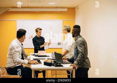 Business people discussing at conference table in board room Stock Photo