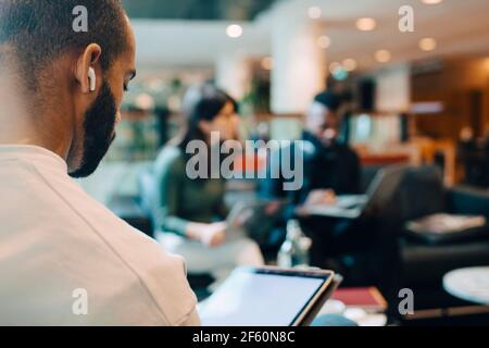 Businessman using digital tablet while sitting in office Stock Photo