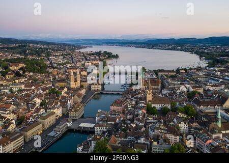 Aerial view of the twilight over Zurich old town where the Limmat river reaches lake Zurich in Switzerland largest city. Stock Photo