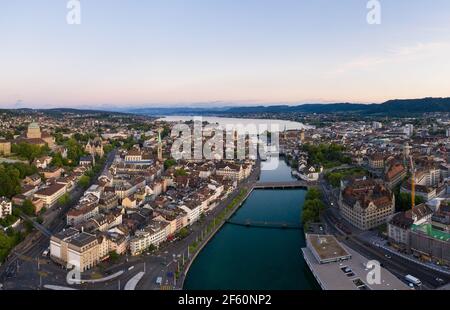 Aerial view of the sunset over Zurich old town and dwontown district with the Limmat river and lake Zurich in Switzerland largest city Stock Photo