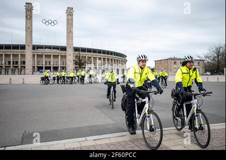 Berlin, Germany. 29th Mar, 2021. Police officers ride their bicycles during a press conference of the Berlin police to present the new bicycle lanes in front of the Olympic stadium. Credit: Fabian Sommer/dpa/Alamy Live News Stock Photo