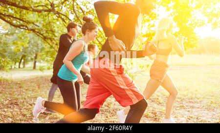 Group of young friends at cross country training for fitness in summer in nature Stock Photo