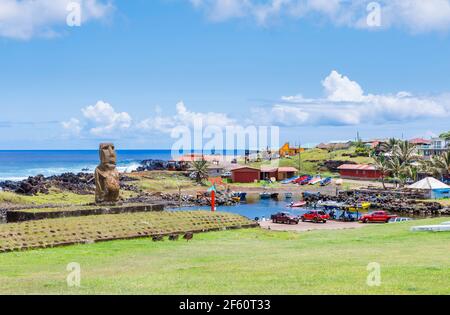 Weathered single moai (statue) standing facing away from the sea in Hanga Roa, the main town on Easter Island (Rapa Nui), Chile Stock Photo