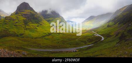 Atmospheric panorama vista view of the Three Sisters of Glencoe valley mountain landscape in the Scottish Highlands, Scotland. Stock Photo