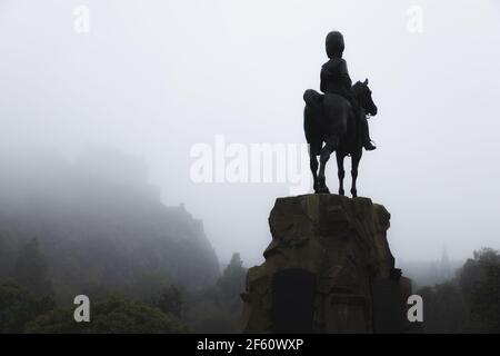 The Royal Scots Greys Monument, an ominous dark presence and equestrian statue over Princes Street Gardens on a misty, foggy day in Edinburgh, Scotlan Stock Photo